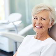 Happy senior woman in dental treatment chair